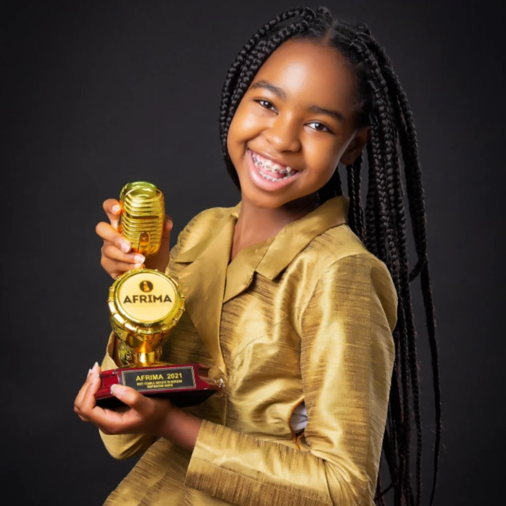 Kenyan artist Shanah Manjeru holding her AFRIMA trophy. A nominee and winner at the awards, she made history as the youngest-ever AFRIMA award winner at age 17
